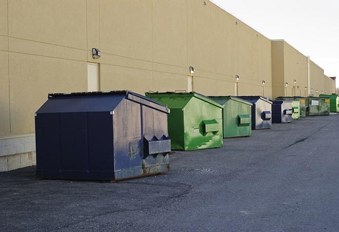 construction workers disposing of debris in large dumpsters in East Boston, MA